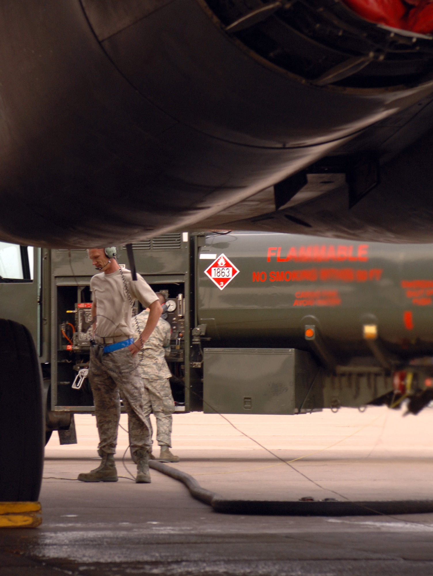 DYESS AIR FORCE BASE, Texas-- Staff Sgt. Alex Speener, B-1 Crew Chief, awaits the ok to attach fuel lines containing a 50/50 blend of synthetic and petroleum to a B-1 Bomber, March 17. The Air Force is currently in the process of evaluating and certifying this alternative fuel, derived from natural gas using the Fischer-Tropsch process, for all Air Force aircraft. (U.S. Air Force photo by Senior Airman Courtney Richardson)
