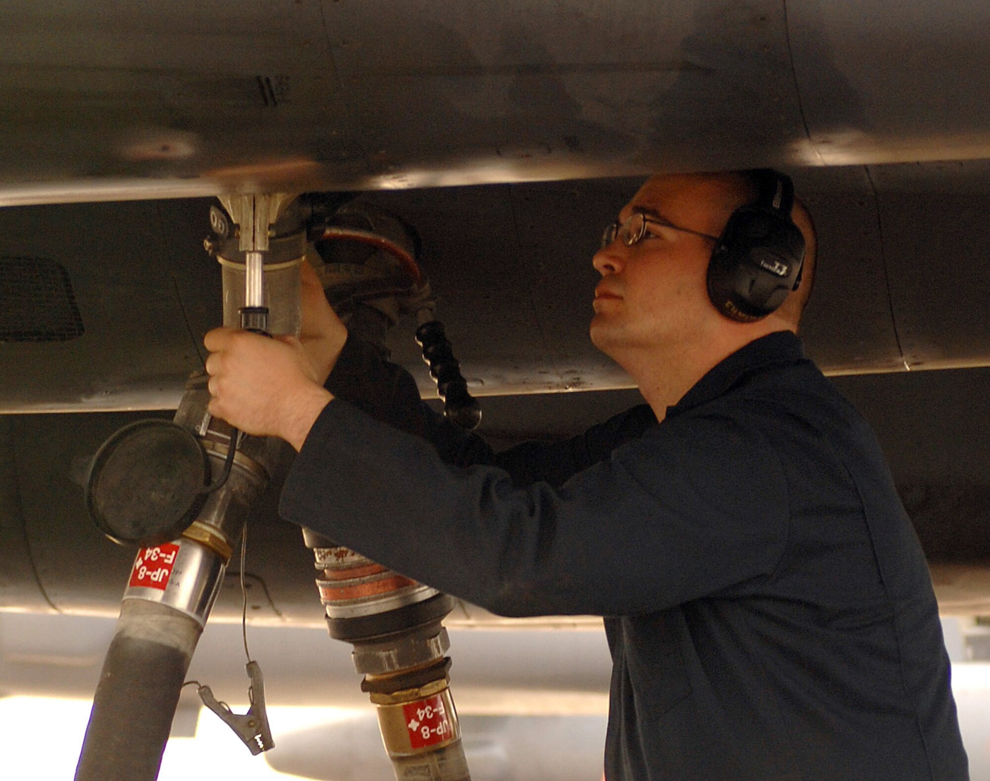 DYESS AIR FORCE BASE, Texas -- Airman 1st Class James Chenevert, 7 AMXS, secures a fuel line containing a 50/50 blend of synthetic and petroleum fuel, March 17. The B-1 Bomber will be the third aircraft to use the 50/50 blend, but the first to fly at supersonic speed. (U.S. Air Force photo by Senior Airman Courtney Richardson)