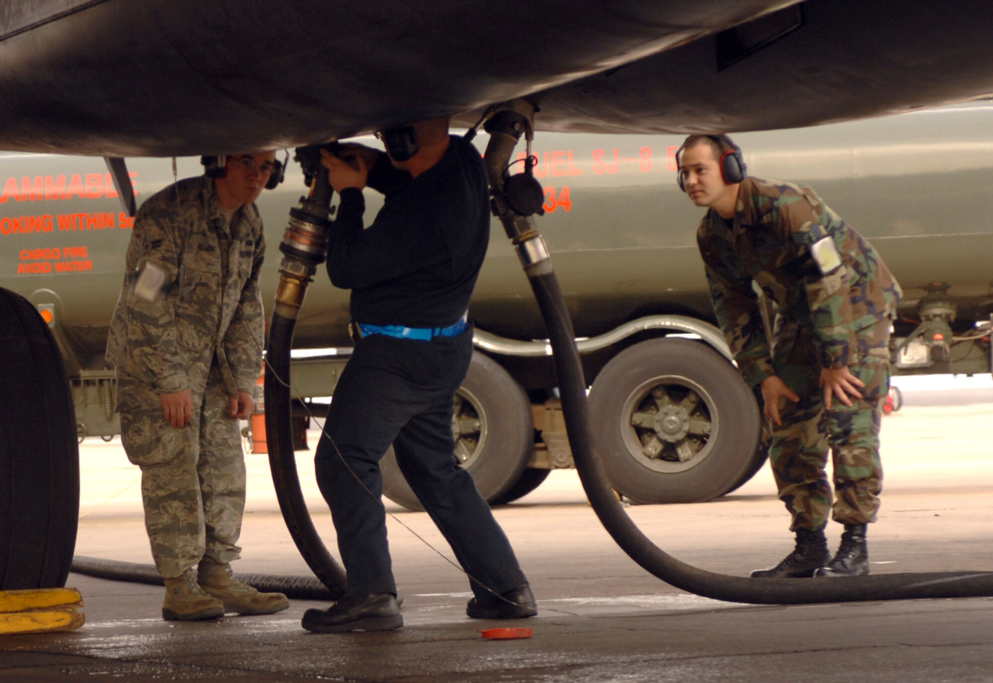 DYESS AIR FORCE BASE, Texas-- Airman 1st Class James Chenevert, 7 AMXS, attaches a fuel line containing a 50/50 blend of synthetic and petroleum fuel to a B-1 Bomber, March 17. This B-1 Bomber will be the Air Force's first aircraft to fly at supersonic speed with the fuel mixture. (U.S. Air Force photo by Senior Airman Courtney Richardson)