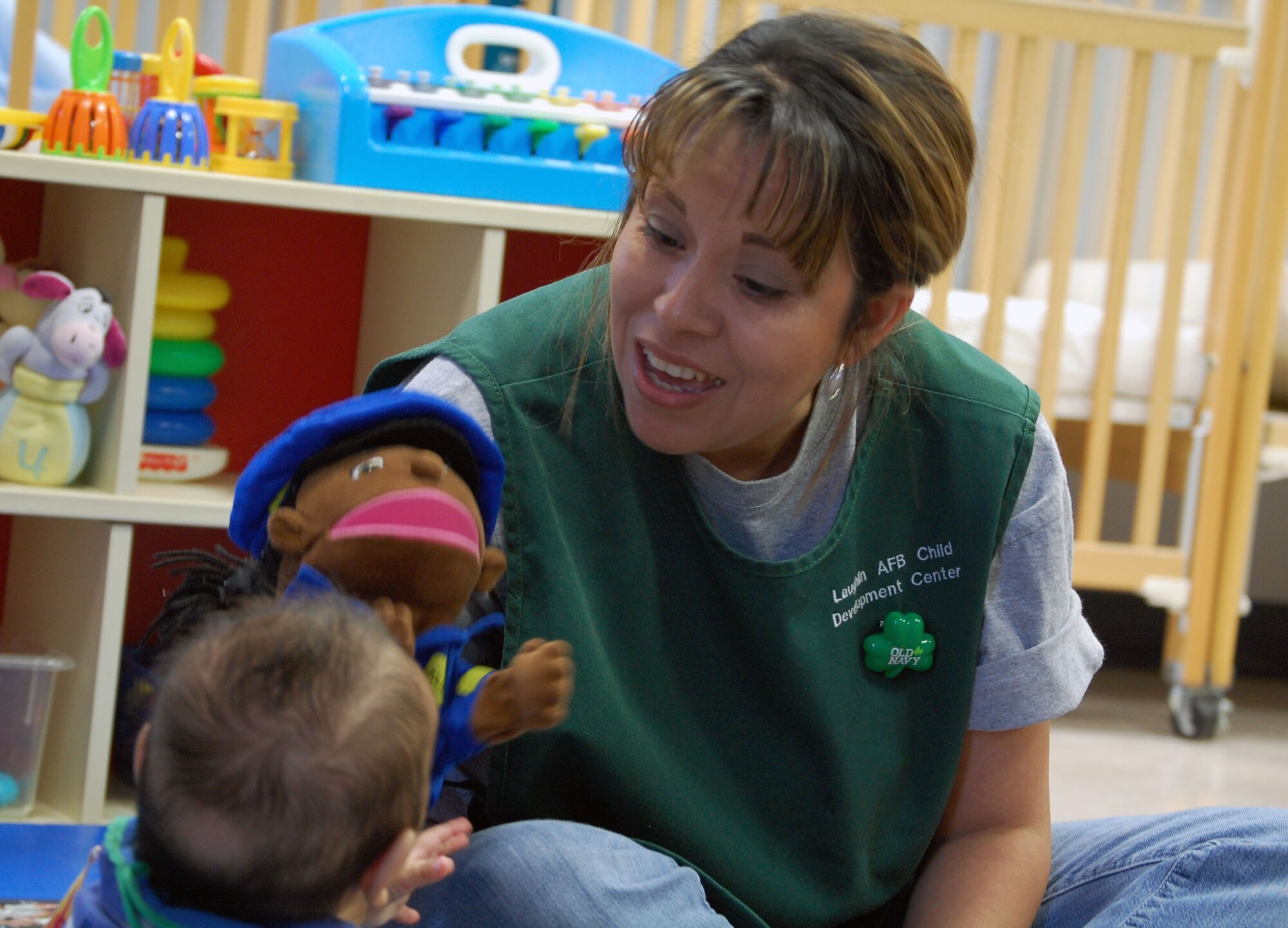LAUGHLIN AIR FORCE BASE, Texas – Irene Trevino, child development provider, sings to a child with a puppet at the Laughlin Child Development Center March 17. Trevino cares for base children at the CDC by feeding, entertaining and teaching them during the day while their parents are working on base. “I really do love working with kids,” said Trevino. “Everyday is exciting with them, they make my job fun.” (U. S. Air Force photo by Airman 1st Class Sara Csurilla)   