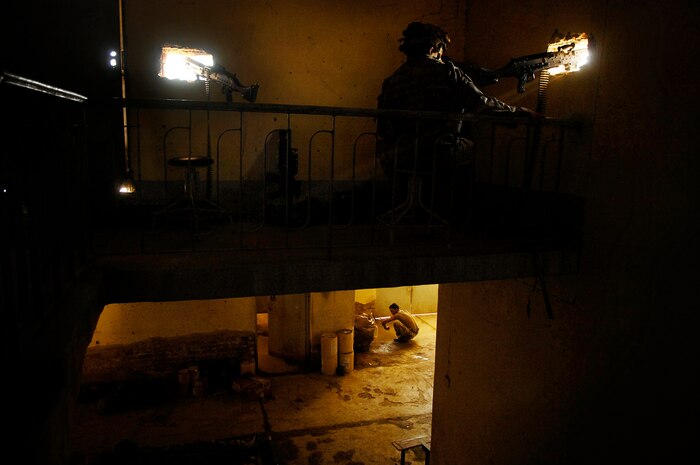 An Iraqi Army Soldier takes time for personal hygiene while a U.S. Army Soldier of Company B, 6th Battalion, 9th Cavalry Regiment, 3rd Brigade Combat Team, 3rd Cavalry Division provides security during combat operations Oct. 4, 2007, in Balure, Iraq. Staff Sgt. Shawn Weismiller won 1st place Feature Photo with this photo in the 2007 Air Force Media Contest. Sergeant Weismiller is a combat photographer with the 1st Combat Camera Squadron. (U.S. Air Force photo/Staff Sgt. Shawn Weismiller)
