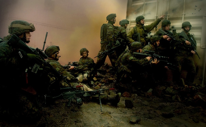 Pinned down behind a building, a platoon of Soldiers from the Australian army wait for suppression fire and smoke before advancing further in Camp Raspberry June 26, 2007, during Exercise Talisman Saber 2007. Tech. Sgt. Jeremy Lock was named Air Force Photographer of the Year and also won 1st place Combat Photography with this photo in the 2007 Air Force Media Contest. Sergeant Lock is a combat photographer with the 1st Combat Camera Squadron. (U.S. Air Force photo/Tech. Sgt. Jeremy Lock)