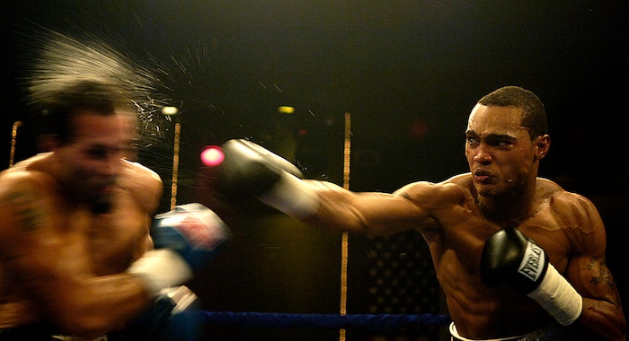 A local Charleston, S.C., boxer lays a crushing right hook during Boxing at the Plex night, Oct. 25, 2007. Senior Airman Clay Lancaster won 1st place Sports Photo with this photo in the 2007 Air Force Media Contest.  Airman Lancaster is a combat photographer with the 1st Combat Camera Squadron. (U.S. Air Force photo/Senior Airman Clay Lancaster)