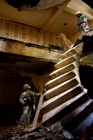 After battling enemy insurgence for a Baqubah stronghold, U.S. Army 2nd Lt. Jonathan Hicks attempts to access the upper levels of the bombed-out building in Baqubah, Iraq, Jan. 22, 2007. Staff Sgt. Stacy Pearsall won 1st place in both the Pictorial Photo and Picture Story Photo categories. Sergeant Pearsall is a combat photographer with the 1st Combat Camera Squadron. (U.S. Air Force photo/Staff Sgt. Stacy Pearsall)