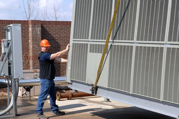 WHITEMAN AIR FORCE BASE, Mo. -Dale Brown, 509th Civil Engineer Squadron makes final adjustments to the 275 ton air conditioning unit position Mar. 14. Mr. Brown helped install the avionic simulator cooling unit to complete the 200 plus man-hour and 200,000 dollar task. (U.S. Air Force photo/Staff Sgt Charles D. Larkin Sr.)  