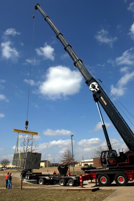WHITEMAN AIR FORCE BASE, Mo. -Members of the 509th Civil Engineer Squadron slowly swing the 275 ton air conditioning unit into position Mar. 14. The 509th CES vigilantly moved the air conditioner into position over a nine foot tall brick wall. (U.S. Air Force photo/Staff Sgt Charles D. Larkin Sr.) 