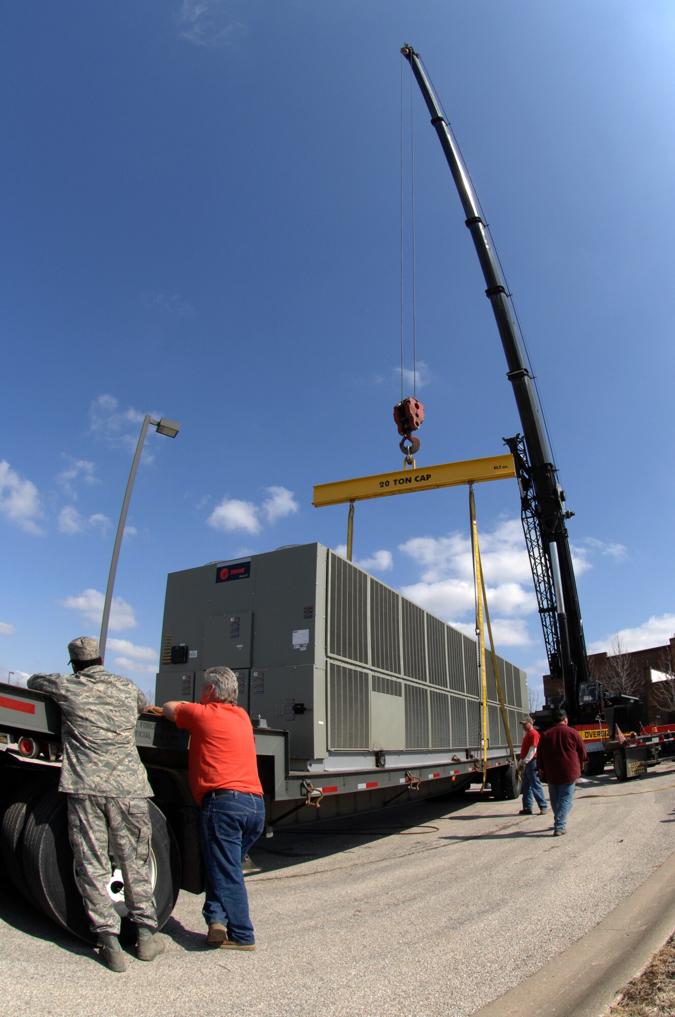 WHITEMAN AIR FORCE BASE, Mo. -Members of the 509th Civil Engineer Squadron awaits the thumbs up to move the 275 ton air conditioning unit Mar. 14. The 509th CES assessed risks involved with moving the enormous cooling unit and took appropriate measures to minimize errors. (U.S. Air Force photo/Staff Sgt Charles D. Larkin Sr.)