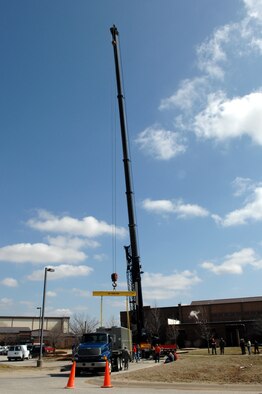 WHITEMAN AIR FORCE BASE, Mo. -Members of the 509th Civil Engineer Squadron prepares to install the 275 ton air conditioning unit Mar. 14. The 509th CES hoisted the avionic simulator cooling unit into place with a 200-foot tall crane brought in specifically for this task. (U.S. Air Force photo/Staff Sgt Charles D. Larkin Sr.)