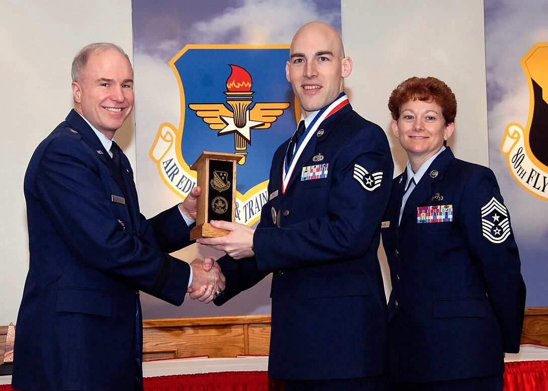 Brig. Gen. Richard Devereaux, 82nd Training Wing commander, presents Staff Sgt. Travis Pyle, 365th Training Squadron, the NCO Instructor of the Year award March 14 at the Annual Tech Training Awards. (U.S. Air Force photo/Harry Tonemah)
