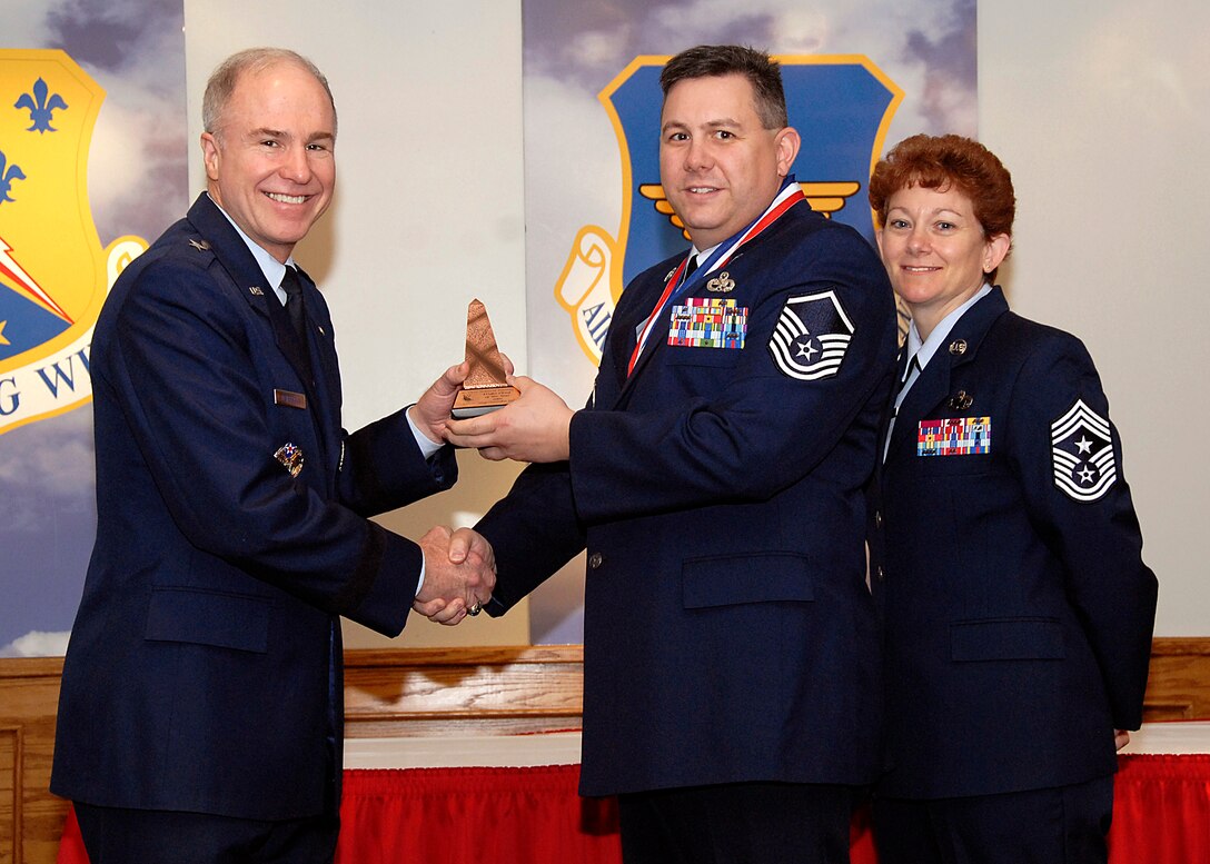 Brig. Gen. Richard Devereaux, 82nd Training Wing commander, presents Master Sgt. Christopher Fraley, 365th Training Squadron, Flight Commander or Flight Chief of the Year award March 14 at the Annual Tech Training Awards. (U.S. Air Force photo/Harry Tonemah)