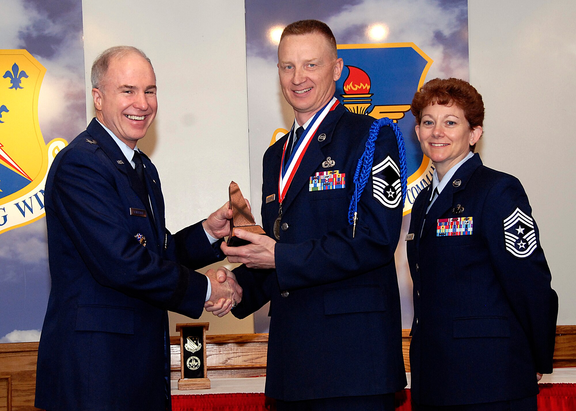 Brig. Gen. Richard Devereaux, 82nd Training Wing commander, presents Senior Master Sgt. Terry Neuharth, 82nd TRW Training Operations, the Senior Military Training Leader of the Year award March 14 at the Annual Tech Training Awards. (U.S. Air Force photo/Harry Tonemah)