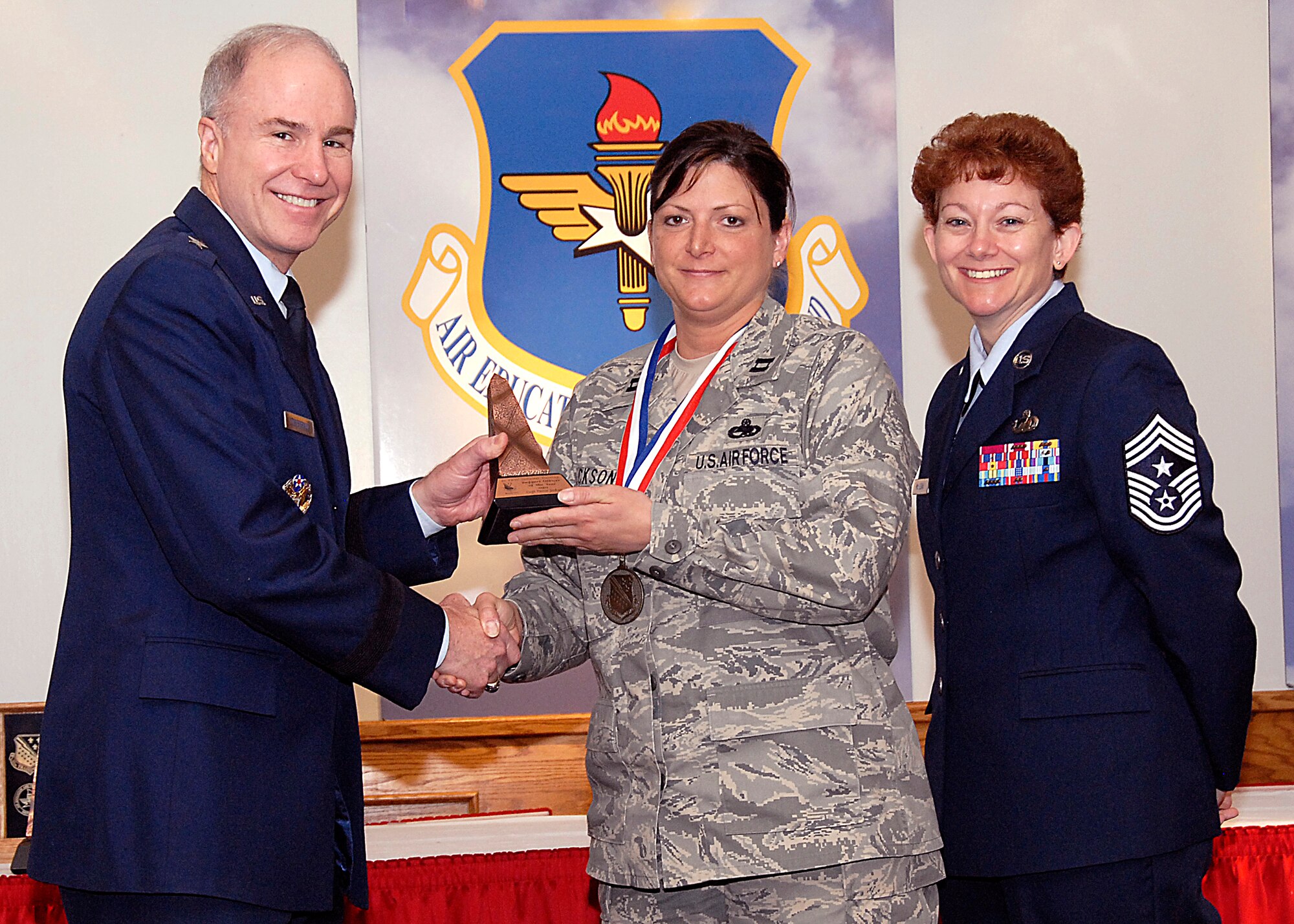 Brig. Gen. Richard Devereaux, 82nd Training Wing commander, presents Capt. Pattie Jackson, 362nd Training Squadron, the Support Officer of the Year award March 14 at the Annual Tech Training Awards. (U.S. Air Force photo/Harry Tonemah)