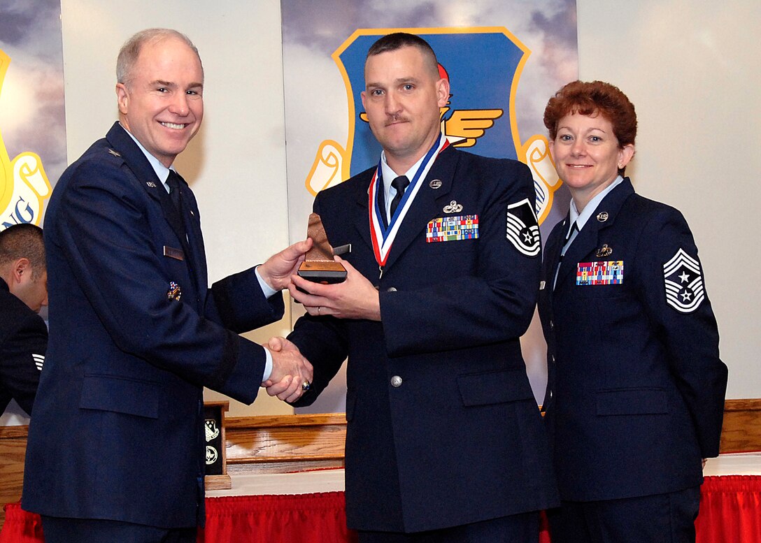 Brig. Gen. Richard Devereaux, 82nd Training Wing commander, presents Master Sgt. Tracy Hurst, 372nd Training Squadron, the Support NCO or Airman of the Year award March 14 at the Annual Tech Training Awards. (U.S. Air Force photo/Harry Tonemah)
