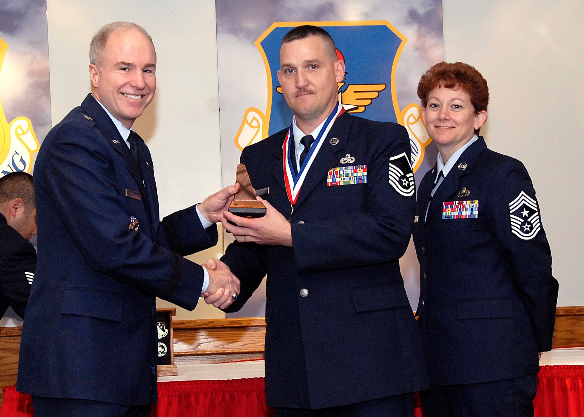 Brig. Gen. Richard Devereaux, 82nd Training Wing commander, presents Master Sgt. Tracy Hurst, 372nd Training Squadron, the Support NCO or Airman of the Year award March 14 at the Annual Tech Training Awards. (U.S. Air Force photo/Harry Tonemah)
