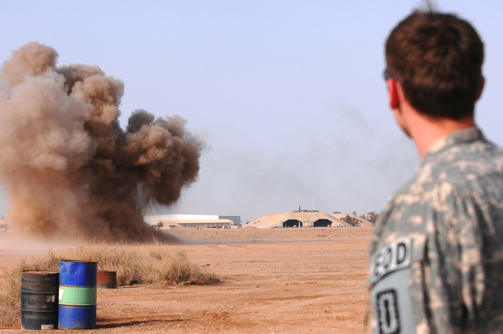 Airman 1st Class Brian Dunnagan stands by as a controlled detonation is successfully completed March 13 at Balad Air Base, Iraq. Unexploded ordnances are collected and destroyed during controlled detonations to prevent them from reentering opposing forces' hands. Airman Dunnagan is a 332nd Expeditionary Civil Engineer Squadron explosive ordnance disposal technician deployed from Hurlburt Field, Fla. (U.S. Air Force photo/Senior Airman Julianne Showalter) 