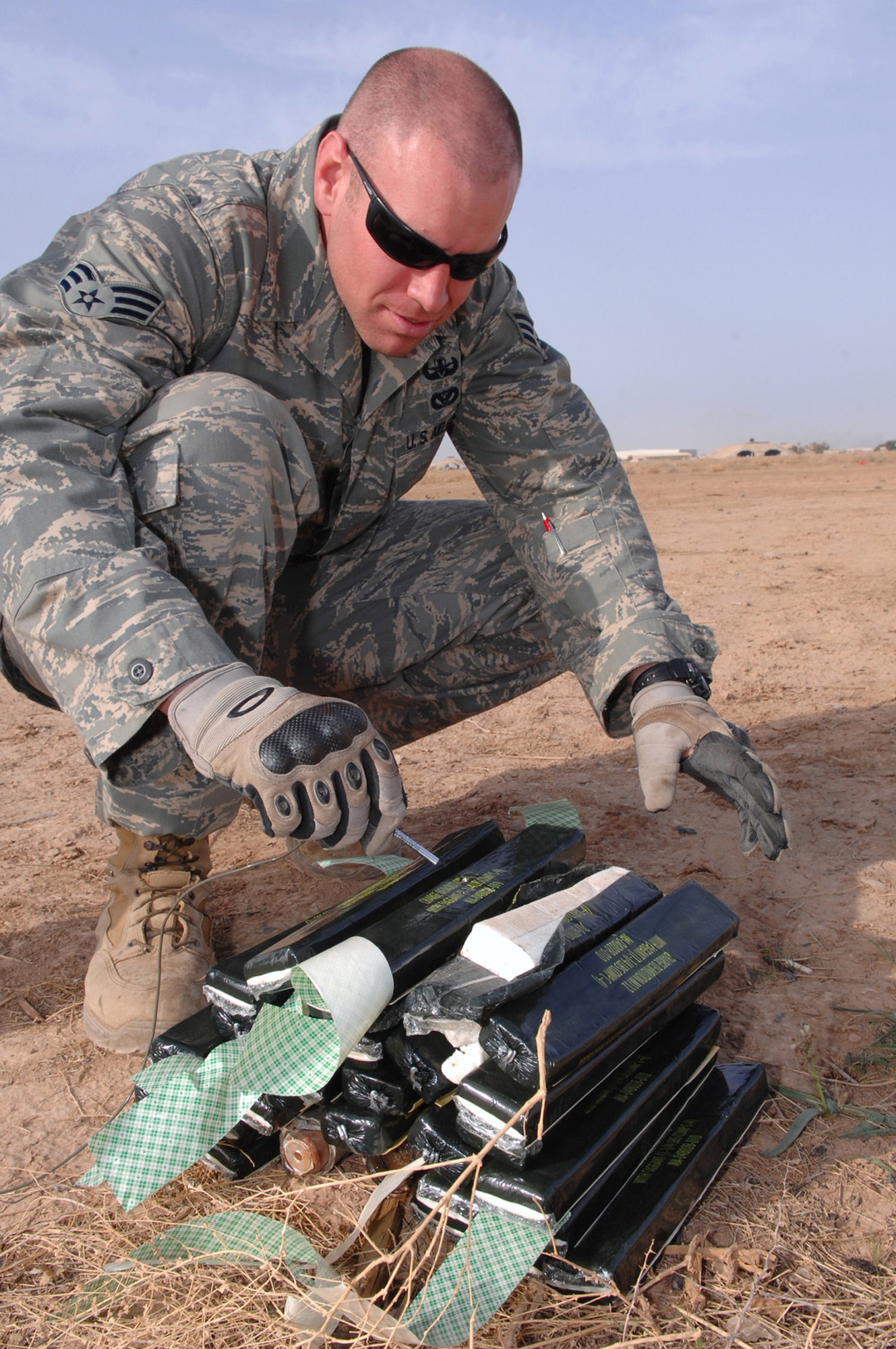 Senior Airman Patrick Heltne places a blasting cap into C-4, an explosive substance, March 13 at Balad Air Base, Iraq. The blasting cap, which is attached to shock tubing, is used to initiate unexploded ordnance detonations from a safe distance. Airman Heltne is a 332nd Expeditionary Civil Engineer Squadron explosive ordnance disposal technician deployed from Ellsworth, S.D. (U.S. Air Force photo/Senior Airman Julianne Showalter) 