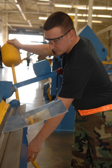 DYESS AIR FORCE BASE, Texas - Senior Airman Justin Shepard, bends a piece of sheet metal for a project March 10. The sheet metal shop work on many different parts of the B-1 and the C-130 such as, the wings, tails and the body. (U.S. Air Force photo by Airman 1st Class Jennifer Romig)