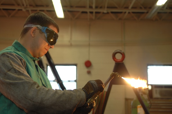 DYESS AIR FORCE BASE, Texas- Senior Airman Alan Fernandez adjusts the mixture of oygen and acetylene going to his torch March 10. The welding shop works on numerous aircraft parts and metal objects that can be fixed.  (U.S. Air Force photo by Airman 1st Class Jennifer Romig)