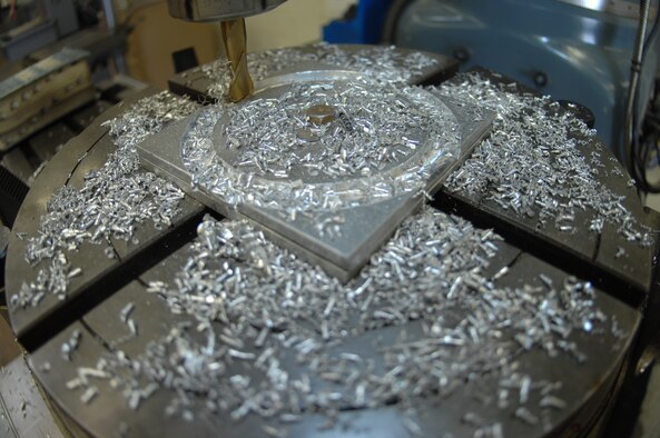 DYESS AIR FORCE BASE, Texas- Airman 1st Class Logan Portell, cuts a for inch circle out of aluminum March 10. Aircraft Metal Technologists practice designs and cuts on small pieces of metal to prepare for the C-130 and B-1 parts. (U.S. Air Force photo by Airman 1st Class Jennifer Romig)