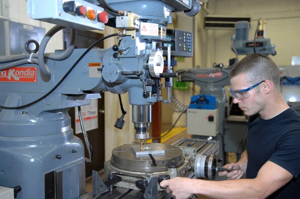 DYESS AIR FORCE BASE, Texas- Airman 1st Class Logan Portell, turns the dial to set the rotary plate on a mill machine March 10. Aircraft Metal Technologists can create, fix, and weld, a number of parts to a C-130 or a B-1. (U.S. Air Force photo by Airman 1st Class Jennifer Romig)