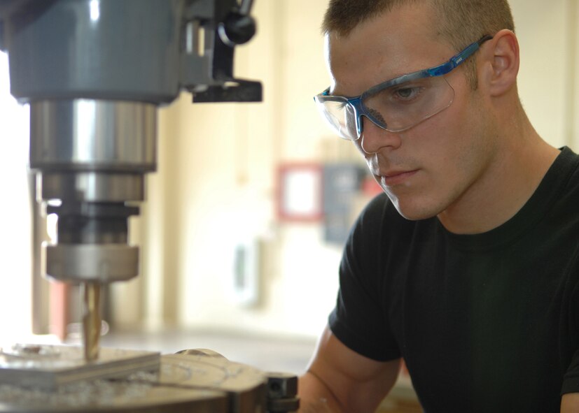 DYESS AIR FORCE BASE, Texas- Airman 1st Class Logan Portell, drils through a piece of aluminum March 10. Aircraft Metal Technologists are given a piece of metal, a design or shape and told to make it by using a specific machine. This training is preparation for the B-1 and C-130 parts that come to their shop and need to be fixed. (U.S. Air Force photo by Airman 1st Class Jennifer Romig)