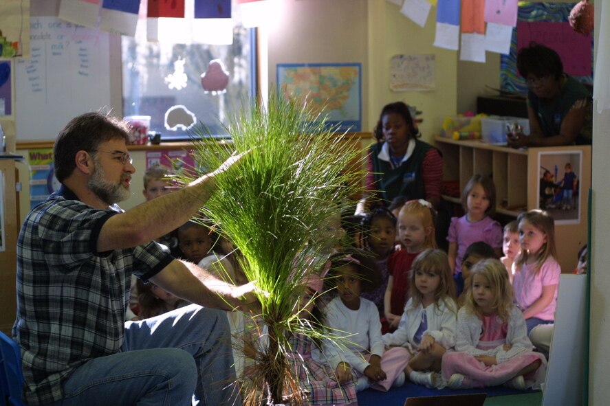 John Crain, 23rd Civil Engineer Squadron environmental flight, explains the value of trees to children at the Child Development Center recently. Each child was given a longleaf pine seedling to take home and plant as part of Moody's Arbor Day celebration. Activities such as this contributed to Moody's recent recognition as a Tree City USA Community for the ninth consecutive year. (Courtesy photo) 