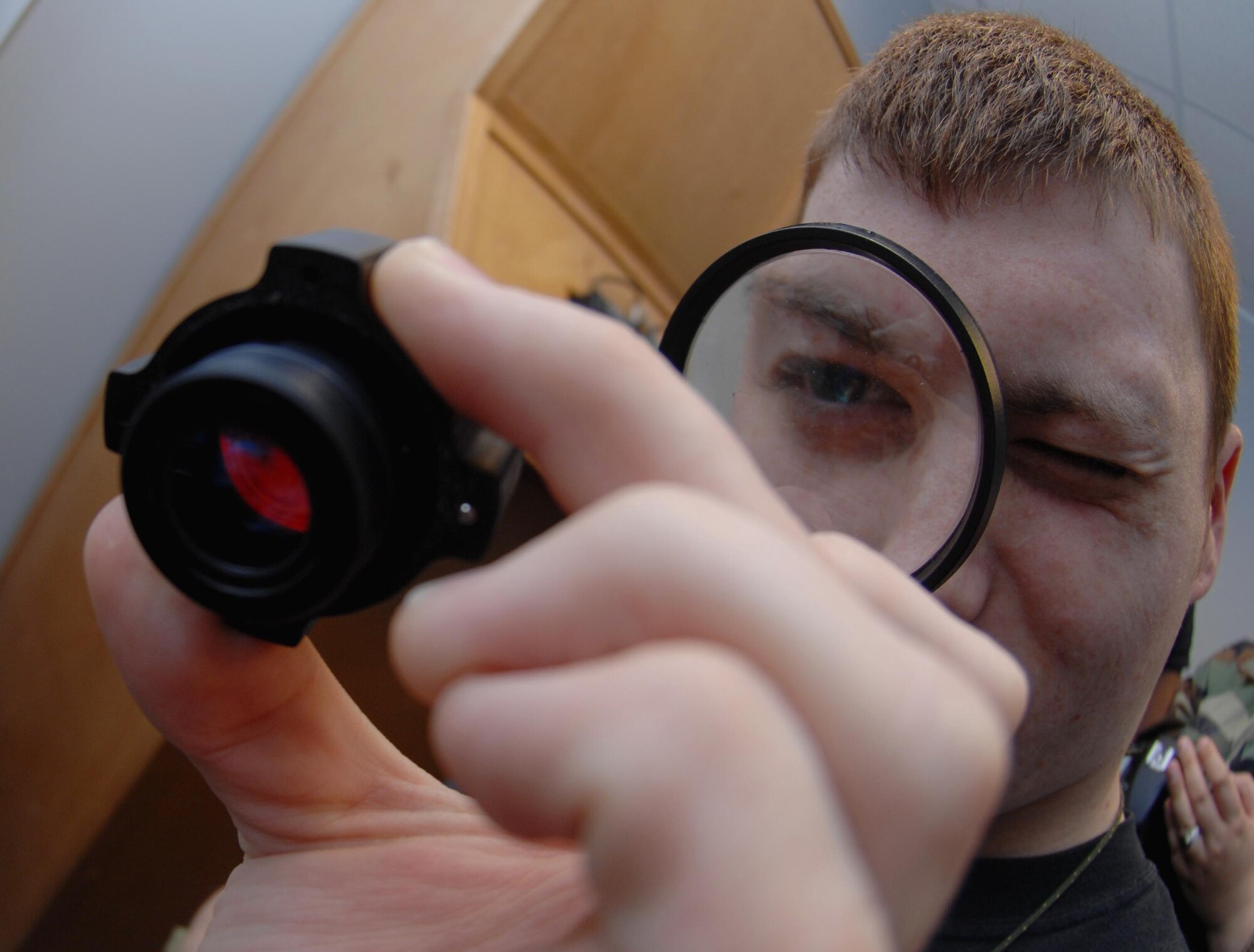 MOODY AIR FORCE BASE, Ga. -- Airman 1st Class William Becham, 71st Rescue Squadron aircrew life support apprentice, inspects a night vision goggle objective lens during exercise Flying Tiger 08-03 here March 12.  Airman Becham was verifying that there weren't  any cracks or foreign debris on the lens.  (U.S. Air Force photo by Senior Airman Angelita Lawrence)
