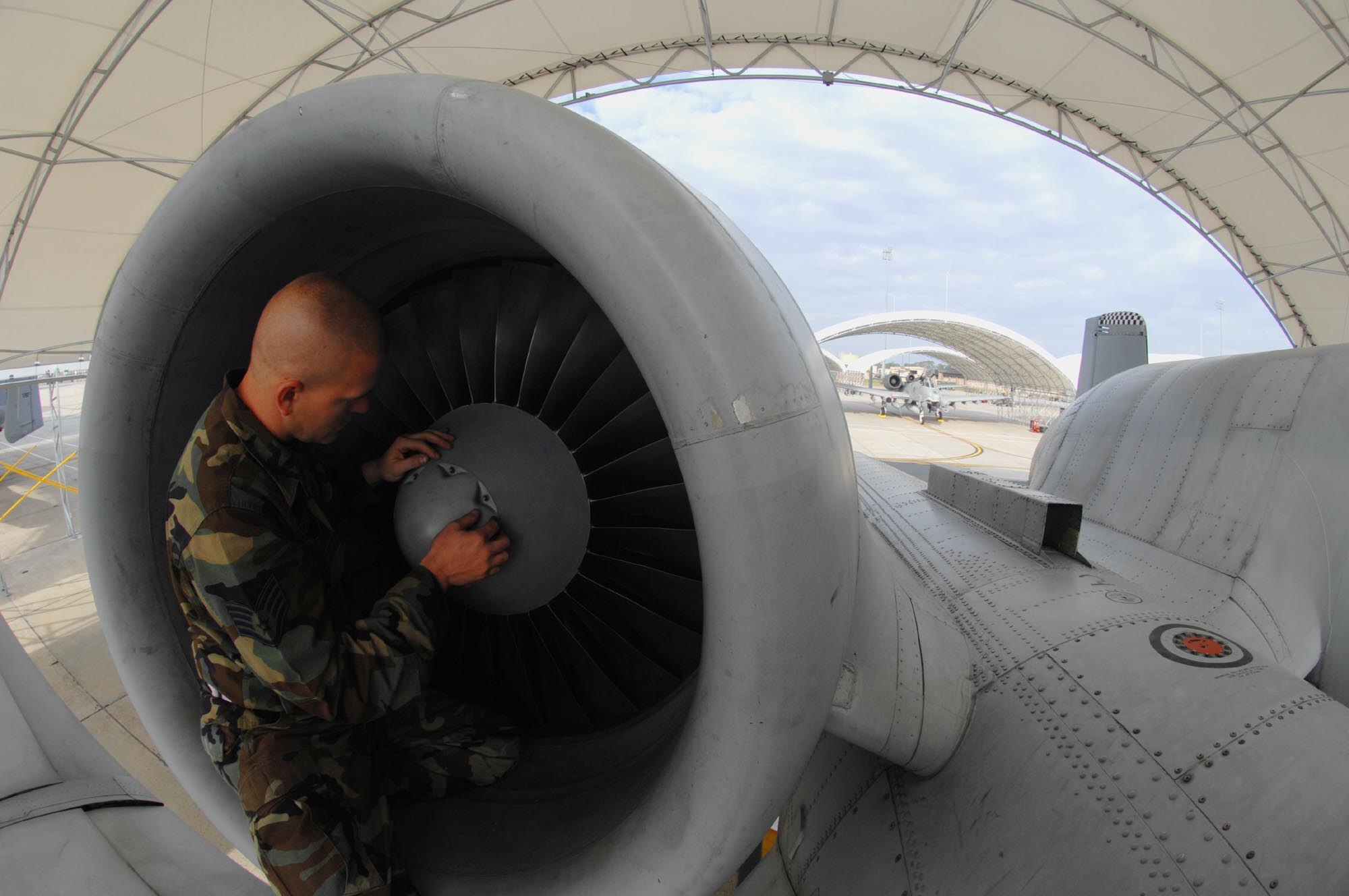 MOODY AIR FORCE BASE, Ga. -- Staff Sgt. Justin Stone, 23rd Aircraft Maintenance Squadron A-10C Thunderbolt II crew chief, inspects one of the engines on a 75th Fighter Squadron A-10C during Exercise Flying Tiger 08-03 here March 11.  Pre-deployment inspections such as this one will closely inspect every system on an aircraft before it leaves for battle. (U.S. Air Force photo by Senior Airman Angelita M. Lawrence)
