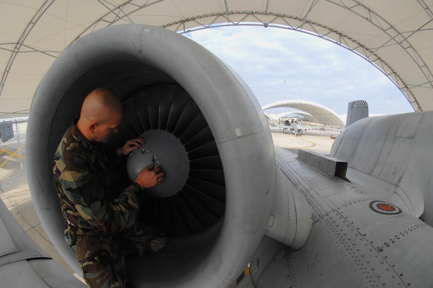 MOODY AIR FORCE BASE, Ga. -- Staff Sgt. Justin Stone, 23rd Aircraft Maintenance Squadron A-10C Thunderbolt II crew chief, inspects one of the engines on a 75th Fighter Squadron A-10C during Exercise Flying Tiger 08-03 here March 11.  Pre-deployment inspections such as this one will closely inspect every system on an aircraft before it leaves for battle. (U.S. Air Force photo by Senior Airman Angelita M. Lawrence)

