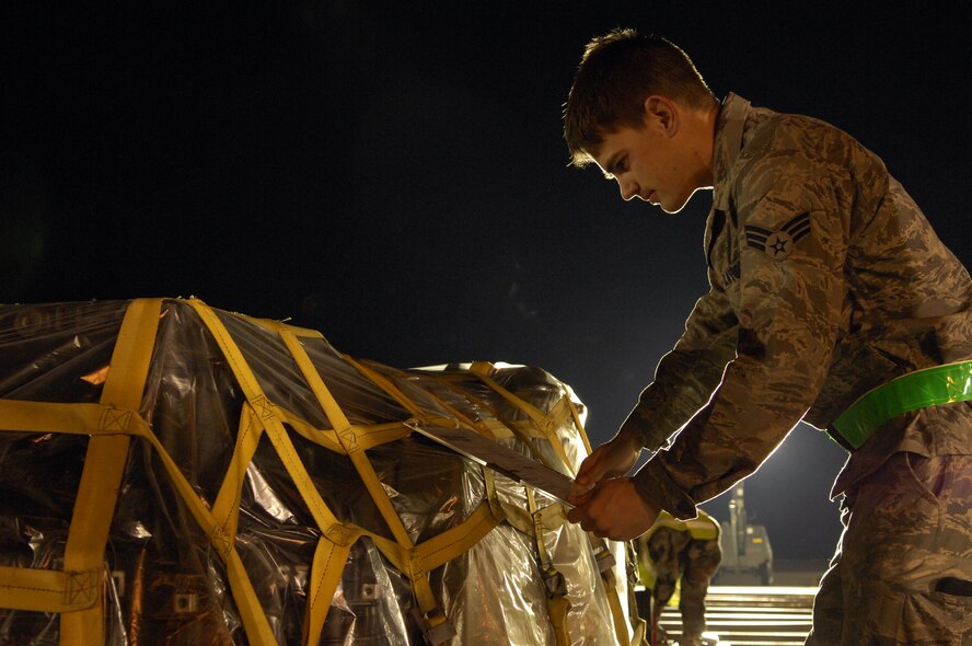 MOODY AIR FORCE BASE, Ga. -- Senior Airman Christopher Colgrove, 23rd Communications Squadron, verifies a transportation control number on a cargo pallet here March 11. These numbers are used to properly route cargo to its proper destination. (U.S. Air Force photo by Senior Airman Elizabeth Rissmiller)