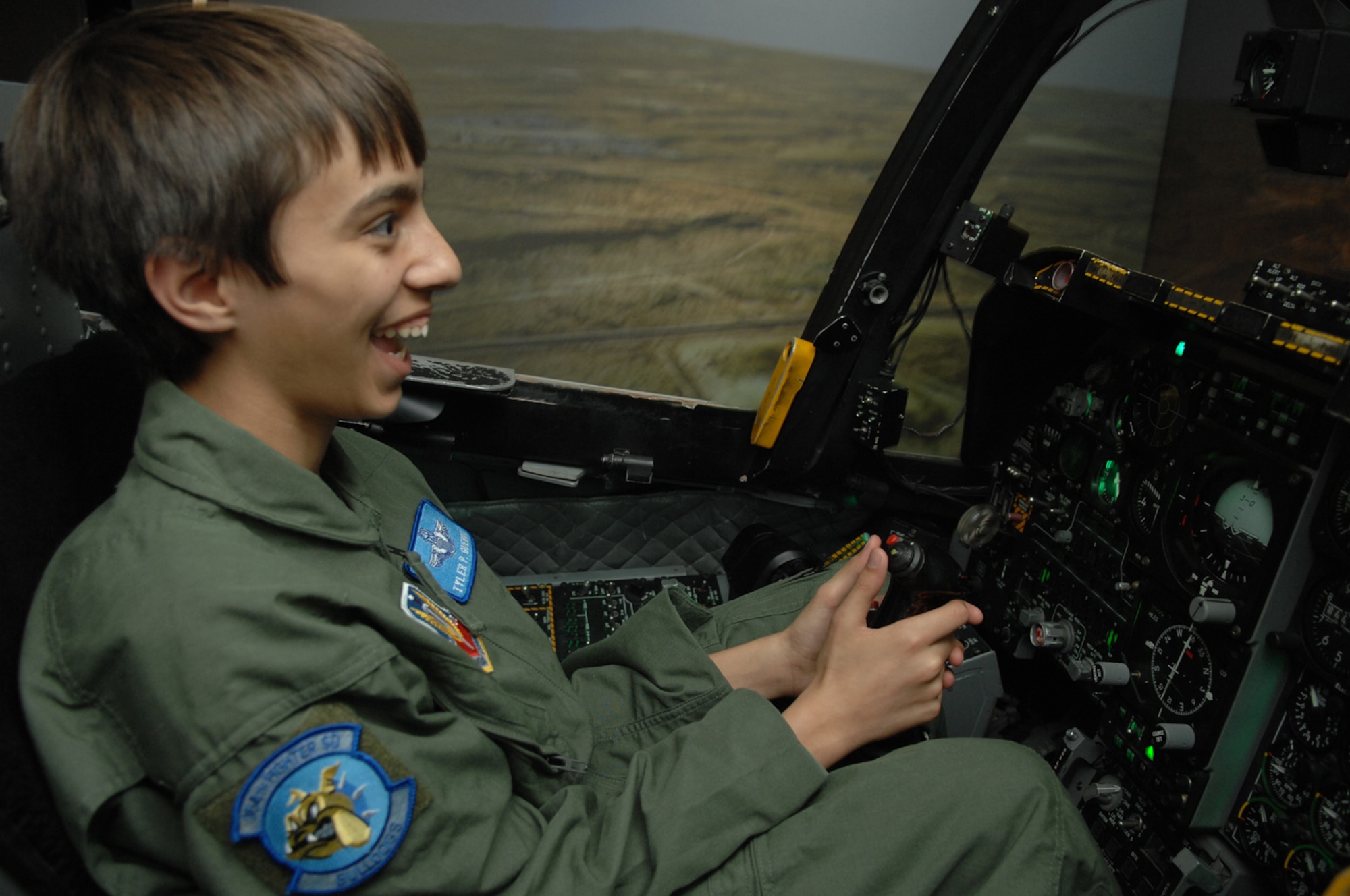 Tyler Guerra sits in an A-10 simulator March 14. Tyler was here for the Pilot for a Day Program. During his visit, Tyler also received a tour of the base, got to sit in an A-10 cockpit and was able to sit in a fire truck. (U.S. Air Force photo by Staff Sgt. Lanie McNeal)