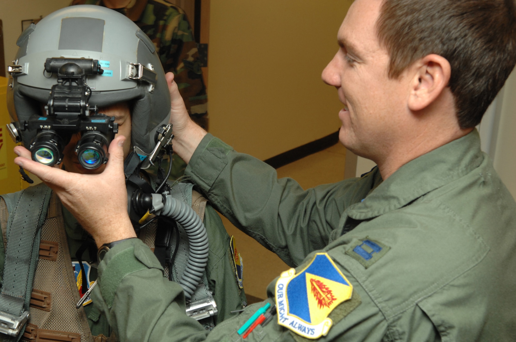 Capt. Scott Silvester, 354th Fighter Squadron pilot, attaches night vision goggles to Tyler Guerras helmet. As part of the Pilot for a Day Program, Tyler experienced the mission of an A-10 fighter pilot during his visit here March 14. (U.S. Air Force photo by Staff Sgt. Lanie McNeal)