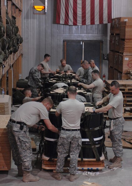 Members of the 11th Quartermaster Detachment create bundles to be dropped at a forward deployed location Feb. 29 at Bagram Air Base, Afghanistan. Bundles can range from 500 to 2,200 pounds and the riggers keep at least 150 contingency bundles ready at all times. (U.S. Air Force photo/Master Sgt. Demetrius Lester) 