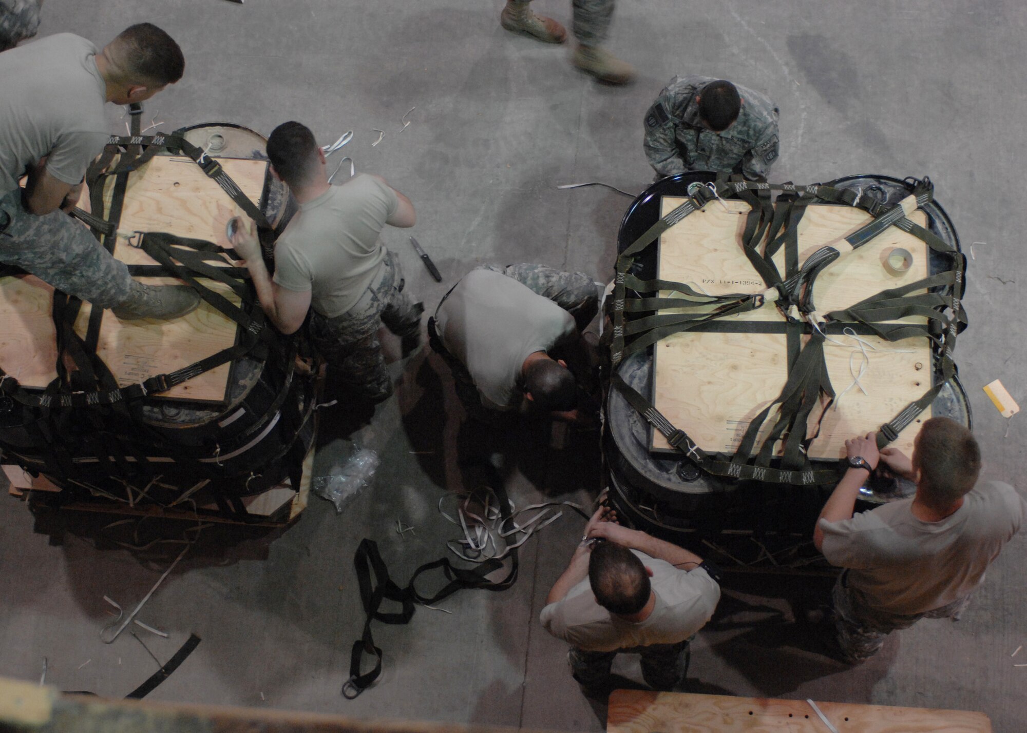 Members of the 11th Quartermaster Detachment create bundles to be dropped at a forward deployed location Feb. 29 at Bagram Air Base, Afghanistan. Bundles can range from 500 to 2,200 pounds and the riggers keep at least 150 contingency bundles ready at all times. (U.S. Air Force photo/Master Sgt. Demetrius Lester)