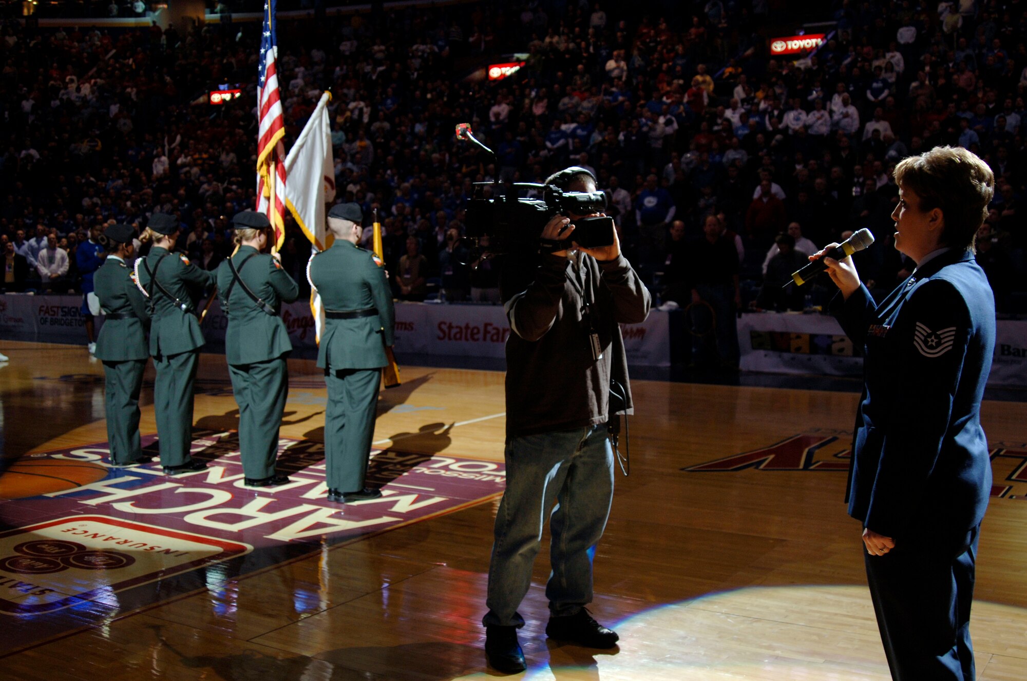 Tech. Sgt. Kristine Keyser, a readiness NCO from the 375th Mission Support Squadron’s Airman and Family Readiness Center, sings the national anthem as the Illinois State University ROTC Honor Guard post the colors prior to the college basketball semifinals of the Missouri Valley Tournament between the Drake Bulldogs and the Creighton Bluejays held at Scottrade Center, in St. Louis.  

U.S. Air Force photo by Tech Sgt. Tony R. Tolley 

