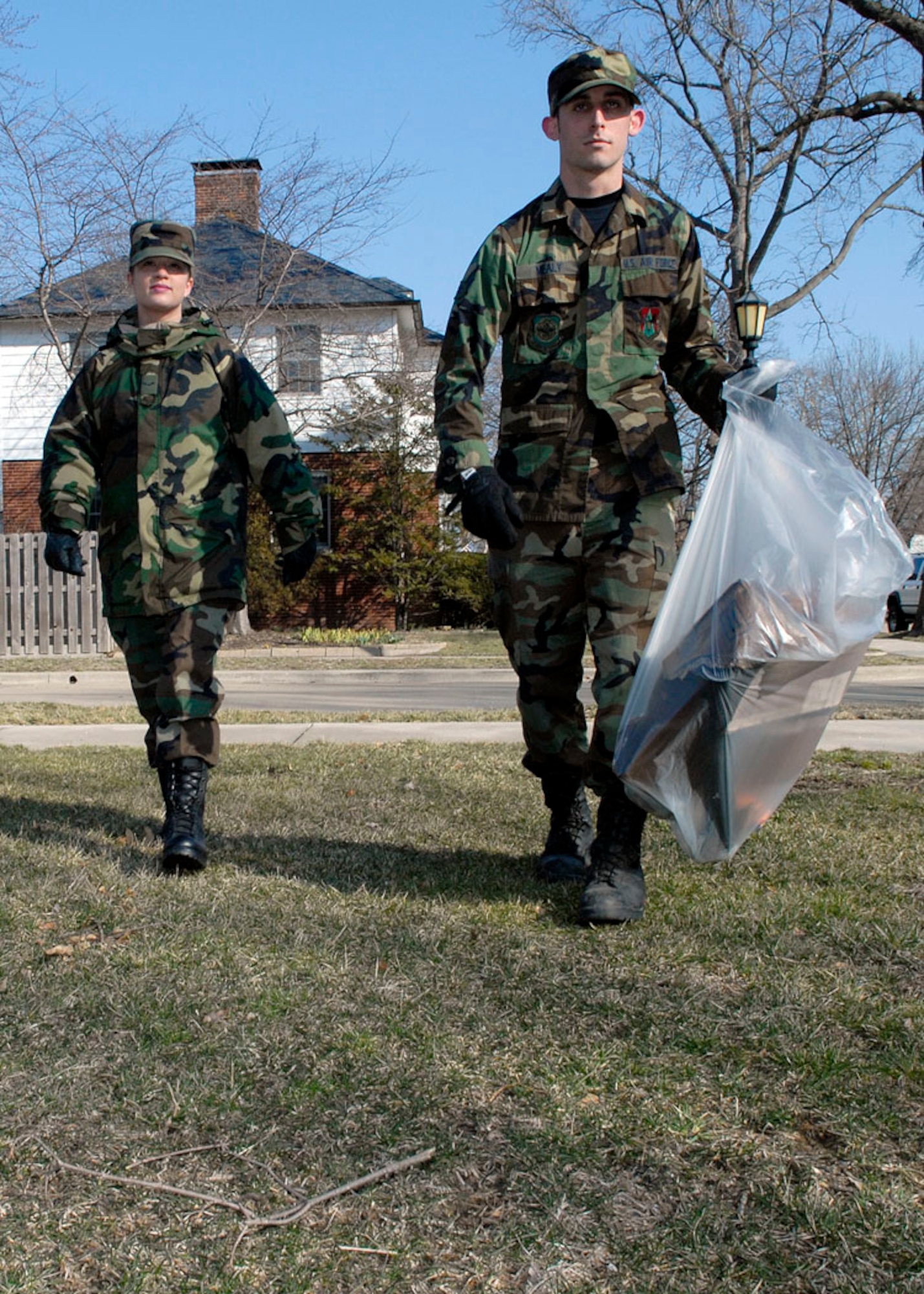 Airman 1st Class Jeanette Colombo, 375th Civil Engineer Squadron electrical power production apprentice, and Airman 1st Class Ryan Mealy, 375th CES electrical power production apprentice, pick up trash to help clean up the base March 10.

Photo by Airman 1st Class Megan Gilliland
