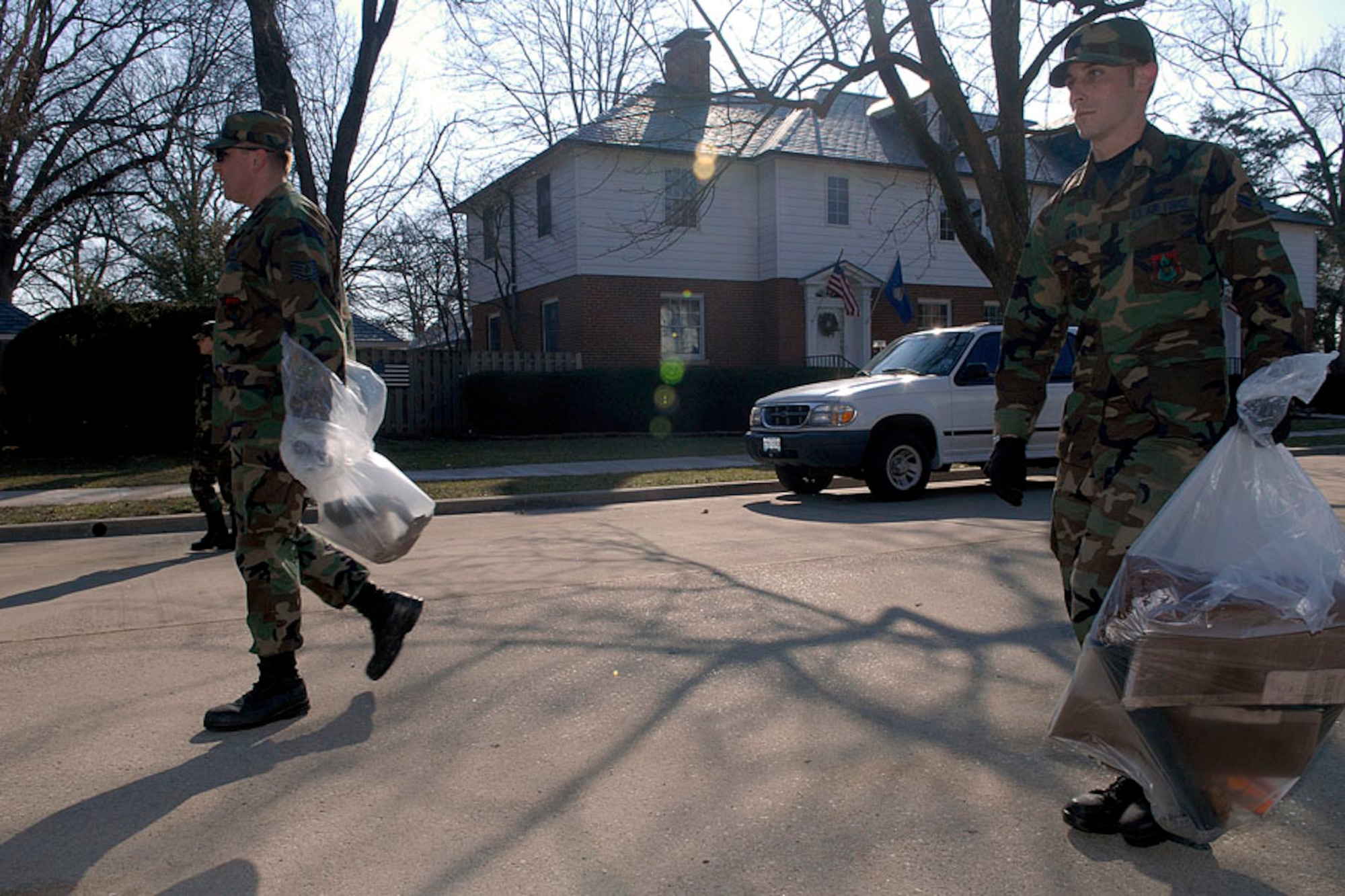 Airman 1st Class Ryan Mealy, 375th Civil Engineer Squadron electrical power production apprentice, and Tech. Sgt. Thomas Smith, 375th CES liquid fuels maintenance craftsman, pick up trash to help clean up the base March 10.

Photo by Airman 1st Class Megan Gilliland
