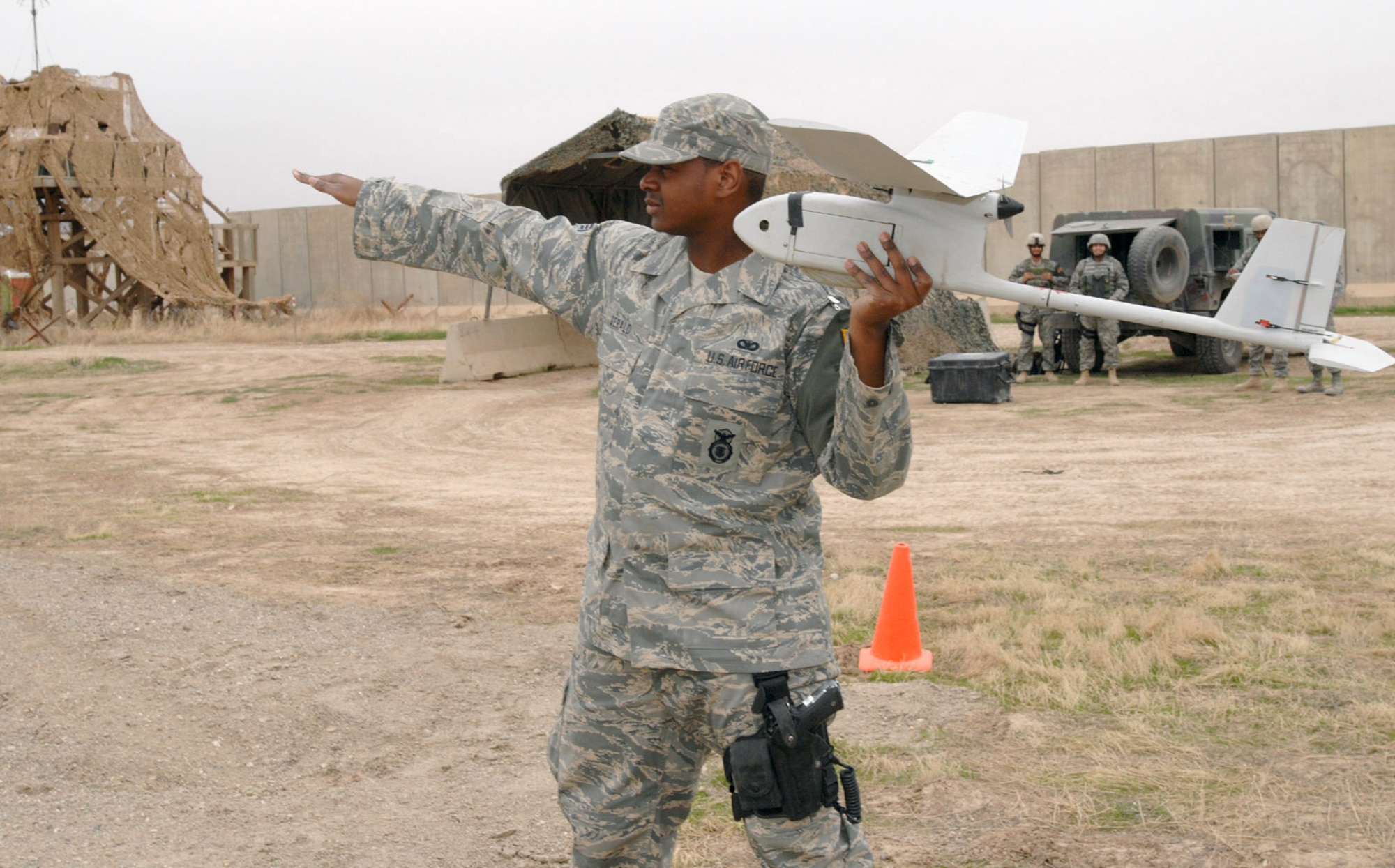 Senior Airman Glenn Gerald prepares to launch an RQ-11 Raven at Kirkuk Regional Air Base, Iraq. Despite weighing less than 5 pounds, these unmanned aerial vehicles play a vital role in securing the base and surrounding neighborhoods. Airman Gerald is a 506th Expeditionary Security Forces Squadron Raven operator. (U.S. Air Force photo/Senior Master Sgt. Don Senger) 
