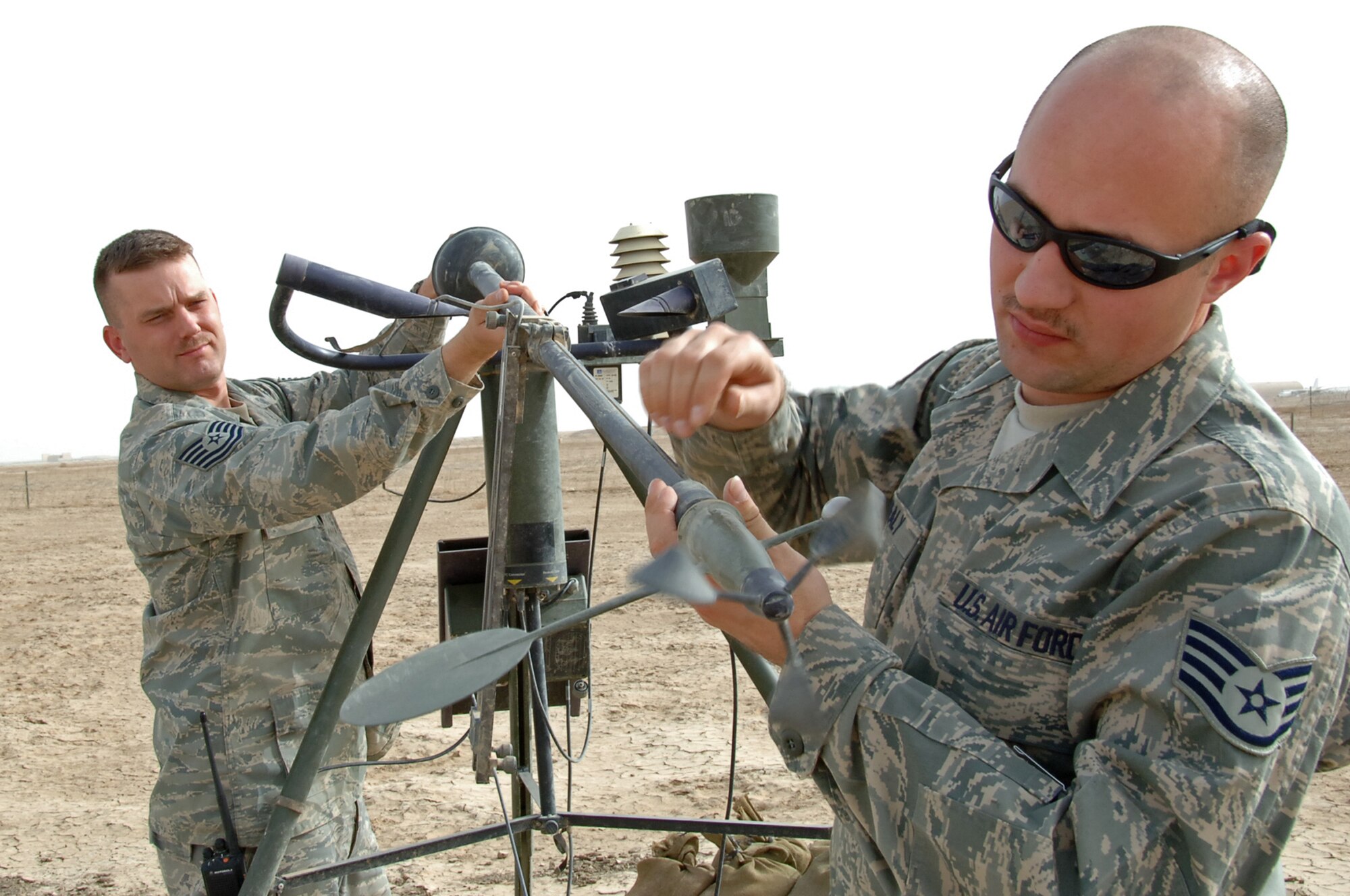 ALI BASE, Iraq ? Staff Sgt. Brandon Healy and Tech. Sgt James Bauman of the 407th Expeditionary Operations Support Squadron, perform preventive maintenance on a TMQ-53, tactical weather sensor package  March 17.  Sergeant Healy is deployed from McGuire AFB, NJ and Sergeant Bauman is deployed from Offutt AF, Neb.   (U. S. Air Force photo / Tech. Sgt. Sabrina Johnson)(Released)