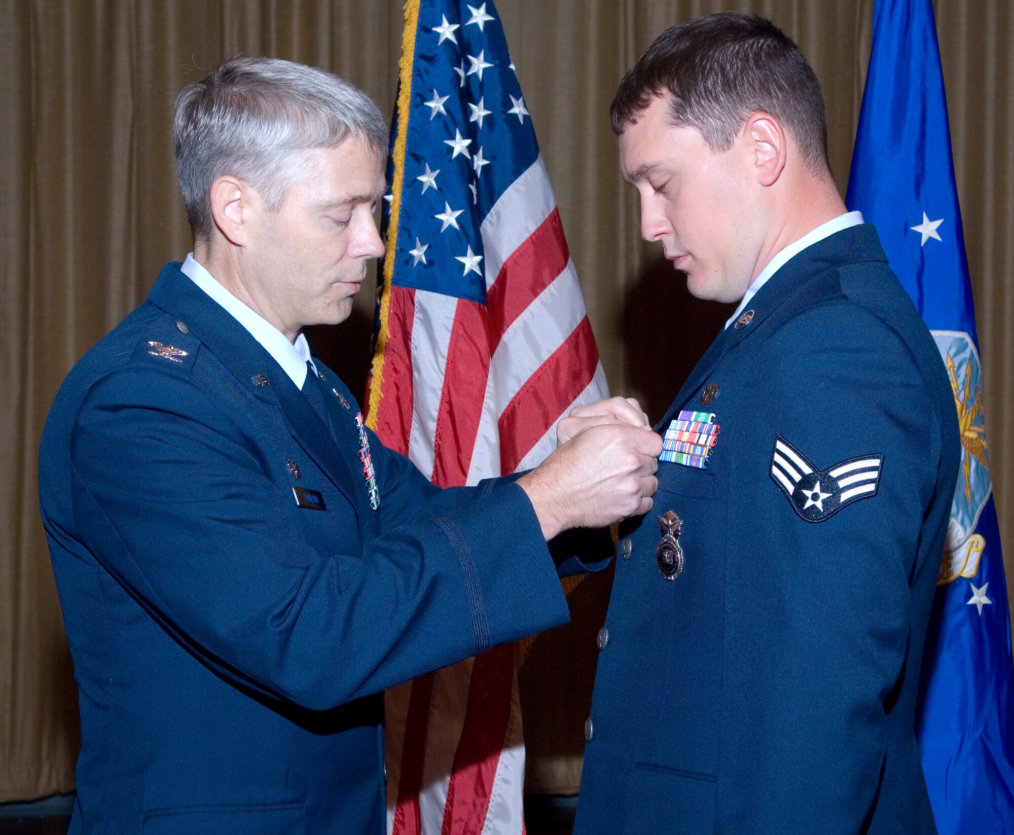Col. Eric Pohland, 96th Air Base Wing commander, pins a Combat Action Medal on Senior Airman Lawrence Taylor, Ground Combat Training Squadron. The award is for Airmen who have been involved in direct fighting situations where they risked their lives in an enemy engagement. 