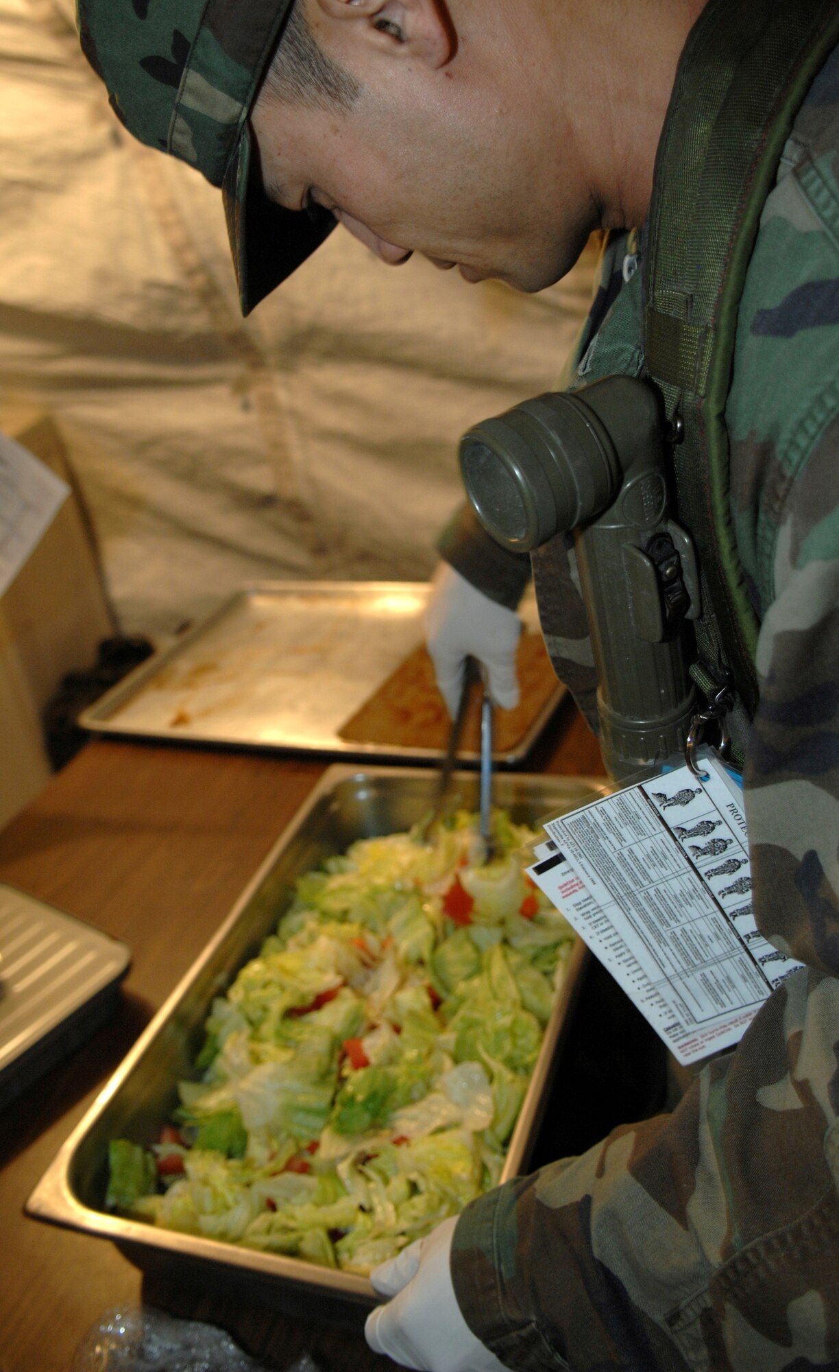 MOUNTAIN HOME AIR FORCE BASE, Idaho -- Staff Sgt. Christopher Soupam, 366th Services Squadron food service specialist, tosses a salad for Airmen during Exercise Coronet White 08-ACC-14 March 16. The 366th Fighter Wing is participating in an Operational Readiness Inspection March 13-21 to test the wing's ability to deploy and take its mission to war. (U.S. Air Force photo by Airman 1st Class Stephany Miller) 