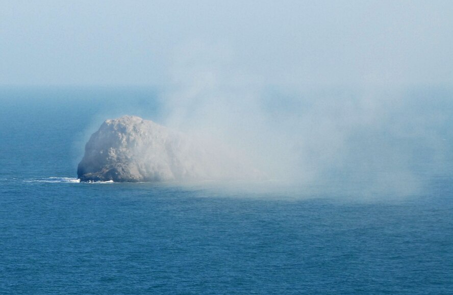 KUNSAN AIR BASE, Republic of Korea -- Smoke is confirmation that the AGM-114 Hellfire missile has made impact with its target here March 14.  Fifteen Apaches from the Army's 2nd Combat Aviation Brigade trained with live fire over Chikdo Range, an island in the West Sea, during a joint "buddy laze" training with Kunsan F-16 pilots.  (U.S. Air Force photo/Senior Airman Steven R. Doty)
