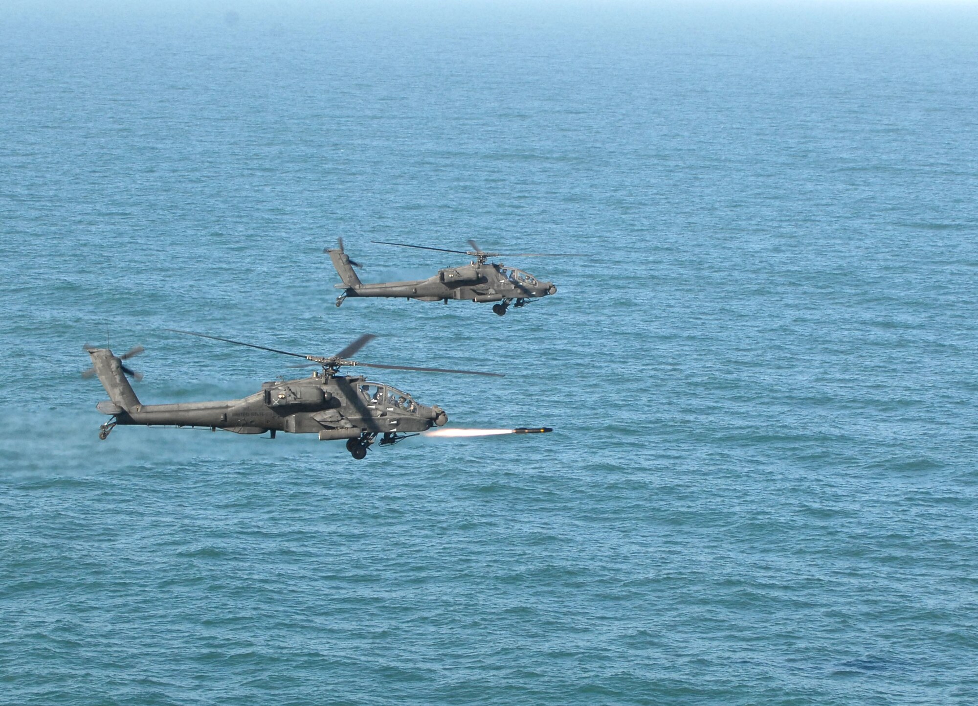 KUNSAN AIR BASE, Republic of Korea -- An Apache AH-64 launches an AGM-114 Hellfire missile at a target range here March 14.  Fifteen Apaches from the Army?s 2nd Combat Aviation Brigade trained with live fire over Chikdo Range, an island in the West Sea, during a joint "buddy laze" training with Kunsan F-16 pilots.  (U.S. Air Force photo/Senior Airman Steven R. Doty)
