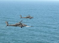 KUNSAN AIR BASE, Republic of Korea -- An Apache AH-64 launches an AGM-114 Hellfire missile at a target range here March 14.  Fifteen Apaches from the Army?s 2nd Combat Aviation Brigade trained with live fire over Chikdo Range, an island in the West Sea, during a joint "buddy laze" training with Kunsan F-16 pilots.  (U.S. Air Force photo/Senior Airman Steven R. Doty)
