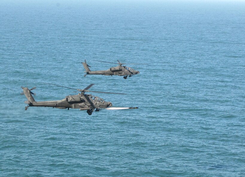KUNSAN AIR BASE, Republic of Korea -- An Apache AH-64 launches an AGM-114 Hellfire missile at a target range here March 14.  Fifteen Apaches from the Army?s 2nd Combat Aviation Brigade trained with live fire over Chikdo Range, an island in the West Sea, during a joint "buddy laze" training with Kunsan F-16 pilots.  (U.S. Air Force photo/Senior Airman Steven R. Doty)