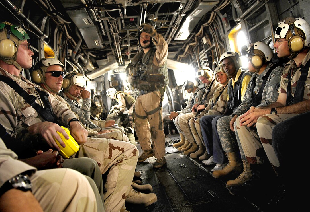 U.S. Army Brig. Gen. Sanford Holman, commander, Combined Joint Task Force-Horn of Africa, and Djiboutian army Gen. Fathi Ahmed Houssein fly aboard a helicopter to a graduation ceremony at Forward Operating Location Ali Sabieh, Djibouti, March 11, 2008. U.S. Army soldiers trained the Djiboutian soldiers on antiterrorism and counterterrorism tactics during a 10-week course covering 27 areas of offensive and defensive operations to better secure Djibouti's borders. The U.S. soldiers are assigned to Guam Army National Guard's 249th Infantry Regiment (Light), Company D, 1st Battalion.