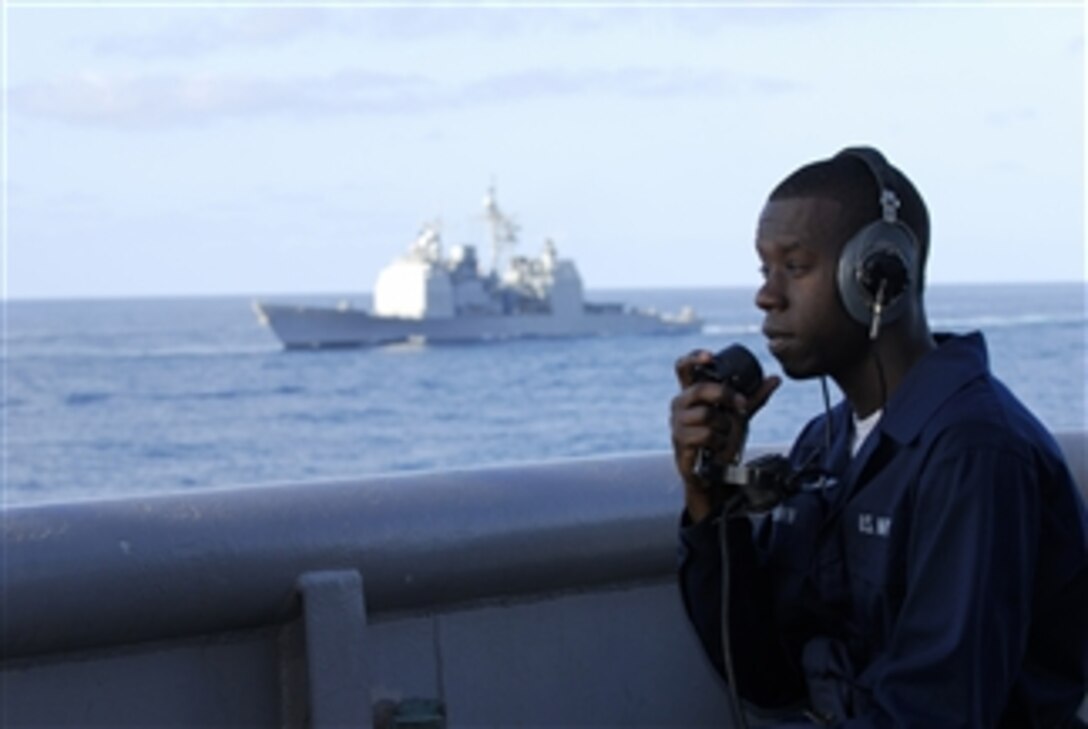U.S. Navy Seaman Lee Brown, assigned to the amphibious assault ship USS Essex (LHD 2), uses a sound powered phone to make reports to the bridge from the starboard aft lookout position during an expeditionary strike force training exercise while underway in the Pacific Ocean on March 16, 2008.  The Essex Expeditionary Strike Group is participating in the exercise with the Nimitz Carrier Strike Group.  