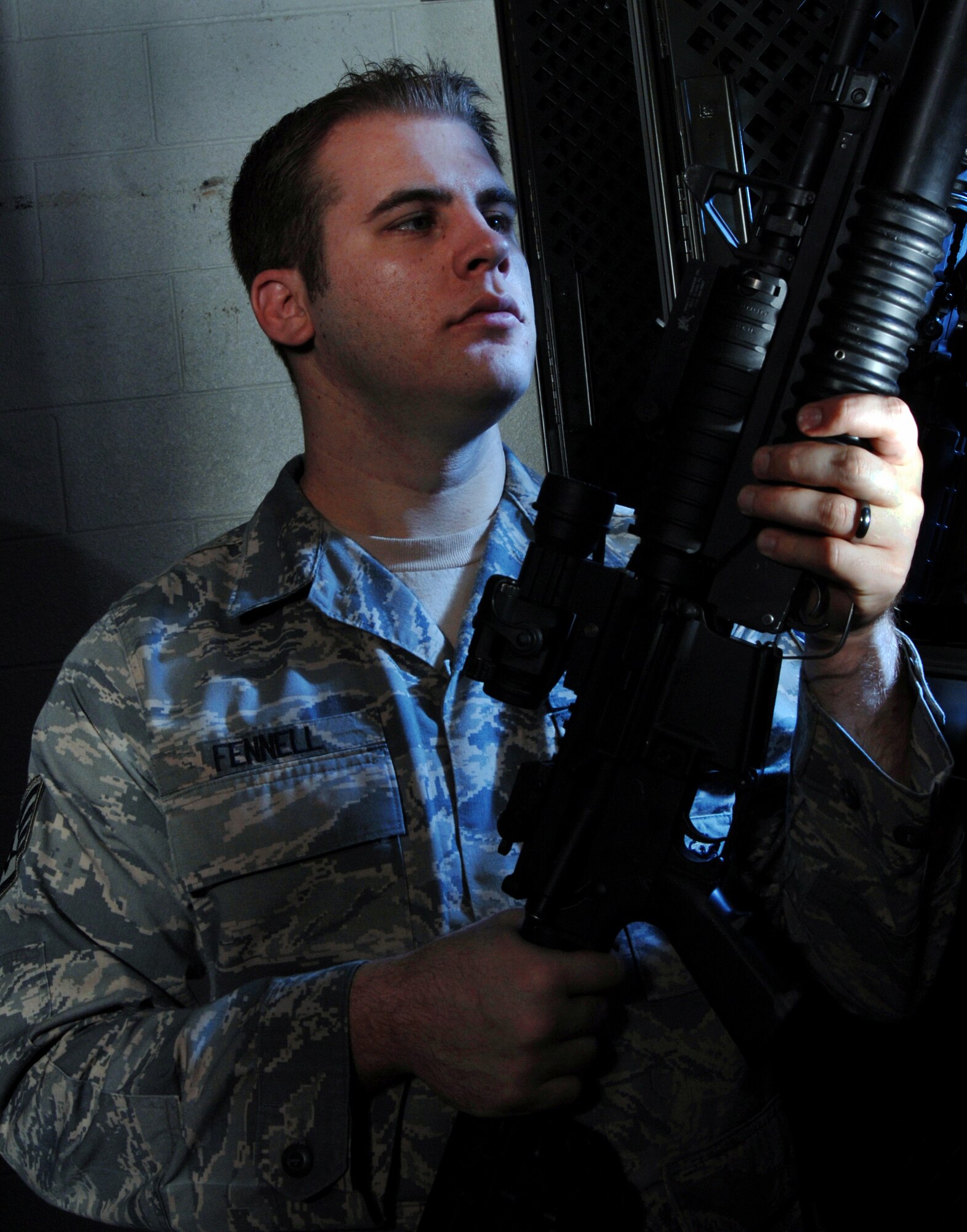 Staff Sgt. Andrew Fennell, an armorer from the 452nd Security Forces Squadron, March Air Reserve Base, Calif., visually inspects the M-68 scope on an 5.56 mm M4 carbine rifle at the armory. (U.S. Air Force photo by Val Gempis)
