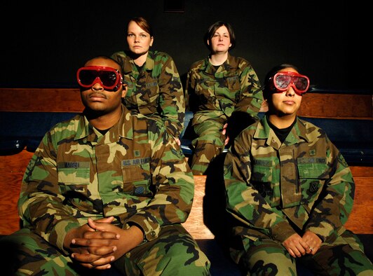 FAIRCHILD AIR FORCE BASE, Wash. –Airman 1st Class Dwayne Marsh and Airman 1st Class Miriam Hernandez, 92nd Aerospace Medicine Squadron aerospace physiology technicians, use goggles to dark adapt during night vision training on March.12. Airman 1st Class Bethany Whiteley and Airman 1st Class Mary Bowie, who are not wearing goggles, experience limited vision in a darkened environment as a result of exposure to bright lights. (U.S. Air Force photo/Staff Sgt. JT May III)