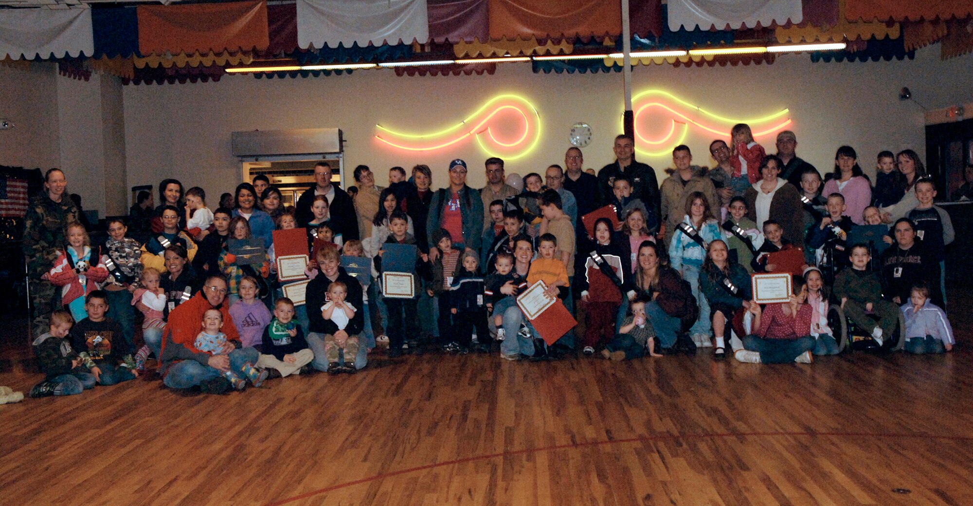 FAIRCHILD AIR FORCE BASE, Wash. – Children of military members pose with acting commander Col. Roger Watkins, 92nd Air Refueling Wing, to show off their certificates of completion after the Kids Understanding Deployment Operations event here March 15. This three-phase event allowed children of military members to focus on the aspects of pre-deployment, deployment and post-deployment operations. (U.S. Air Force photo/Airman 1st Class Darlene West)